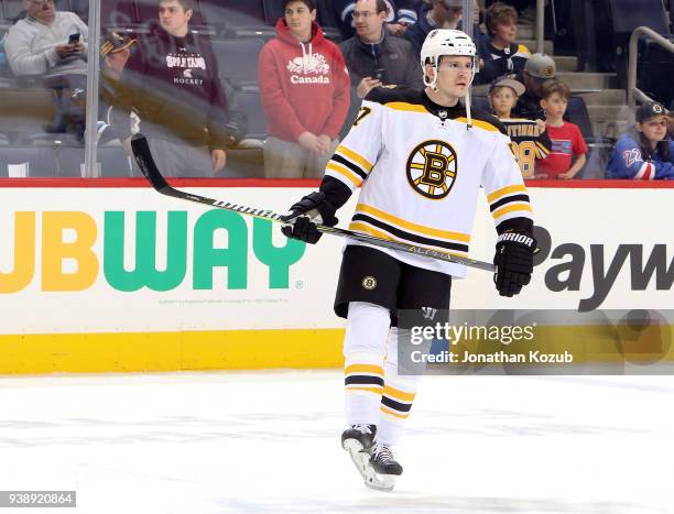 Tommy Wingels of the Boston Bruins takes part in the pre-game warm up prior to NHL action against the Winnipeg Jets at the Bell MTS Place on March...