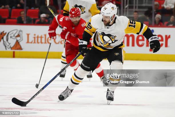 Riley Sheahan of the Pittsburgh Penguins brings the puck up ice in front of Henrik Zetterberg of the Detroit Red Wings during the first period at...