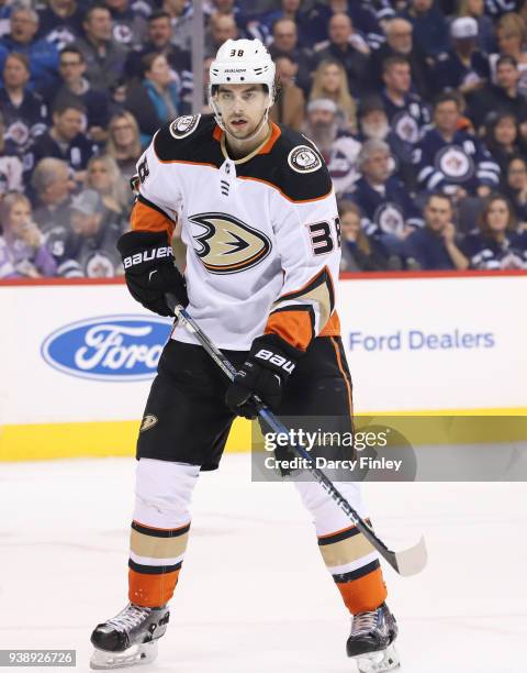 Derek Grant of the Anaheim Ducks keeps an eye on the play during second period action against the Winnipeg Jets at the Bell MTS Place on March 23,...