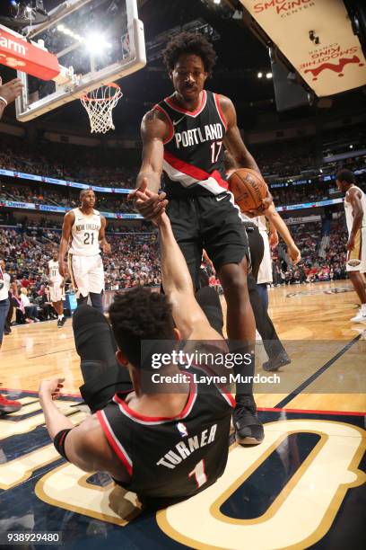 Ed Davis assists Evan Turner of the Portland Trail Blazers off the floor during the game against the New Orleans Pelicans on March 27, 2018 at the...