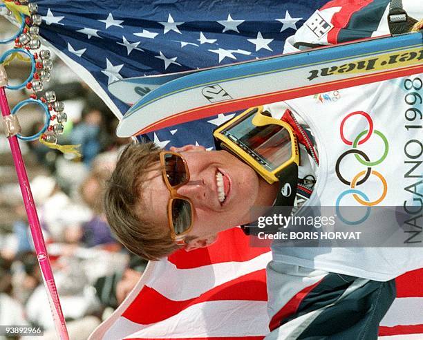 Jonny Moseley holds the US flag as he celebrates after winning the men's Olympic moguls freestyle skiing event at Lizuna Kogen near Nagano 11...