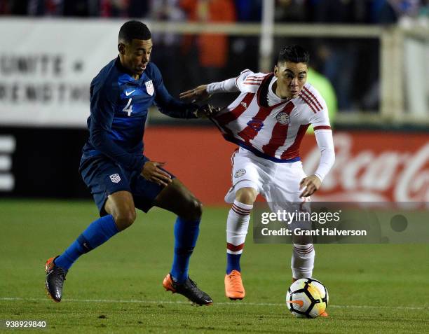 Tyler Adams of United States grabs Miguel Almiron of Paraguay as they battle for the ball during their game at WakeMed Soccer Park on March 27, 2018...