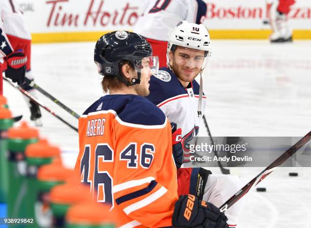 Pontus Aberg of the Edmonton Oilers exchanges words with Alexander Wennberg of the Columbus Blue Jackets on March 27, 2018 at Rogers Place in...