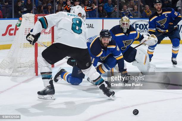 Robert Bortuzzo of the St. Louis Blues defends the net against Joe Pavelski of the San Jose Sharks at Scottrade Center on March 27, 2018 in St....