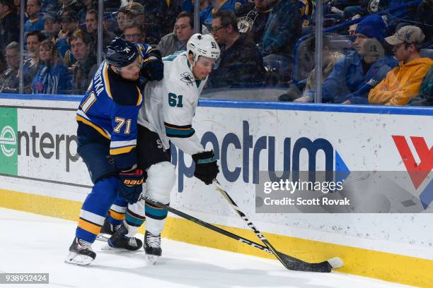Justin Braun of the San Jose Sharks attempts to control the puck as Vladimir Sobotka of the St. Louis Blues pressures at Scottrade Center on March...