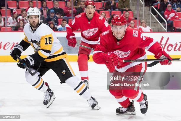 Joe Hicketts of the Detroit Red Wings races after the puck followed by Riley Sheahan of the Pittsburgh Penguins as Danny DeKeyser of the Wings...