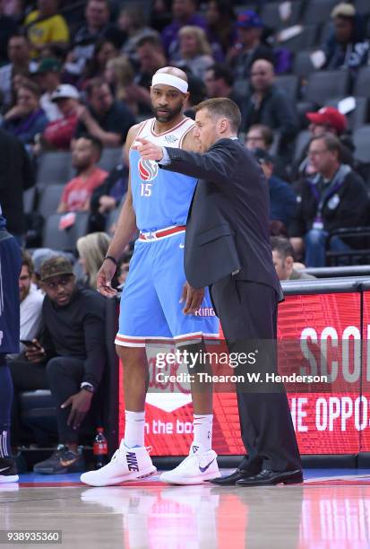 Vince Carter of the Sacramento Kings talks with head coach David Joerger against the Detroit Pistons during an NBA basketball game at Golden 1 Center...