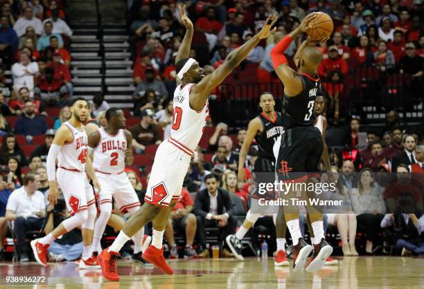 Houston Rockets guard Chris Paul takes a three point shot defended by Chicago Bulls forward Noah Vonleh in the first half at Toyota Center on March...