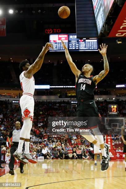 Chicago Bulls guard Justin Holiday takes a three point shot defended by Houston Rockets guard Gerald Green in the first half at Toyota Center on...