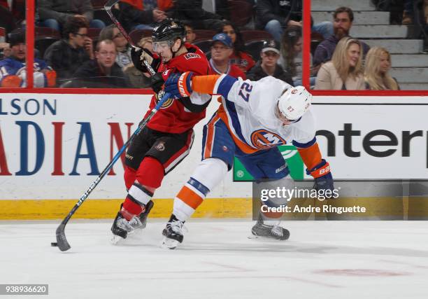 Jean-Gabriel Pageau of the Ottawa Senators battles for position against Anders Lee of the New York Islanders at Canadian Tire Centre on March 27,...
