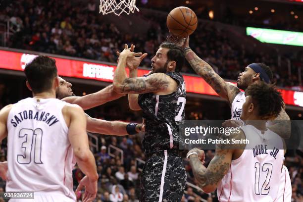 Joffrey Lauvergne of the San Antonio Spurs tries to rebound in front of multiple Washington Wizards players during the second half at Capital One...