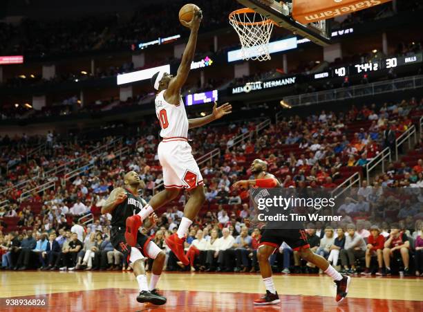 Chicago Bulls forward Noah Vonleh goes up for a lay up defended by Houston Rockets guard Chris Paul and Houston Rockets forward PJ Tucker in the...