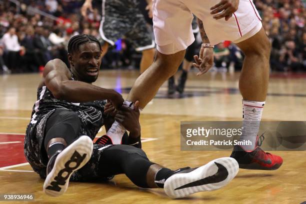 Brandon Paul of the San Antonio Spurs grabs a Washington Wizards players leg during the second half at Capital One Arena on March 27, 2018 in...