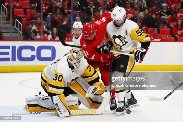 Matt Murray of the Pittsburgh Penguins tries to watch the puck newt to Kris Letang and Luke Glendening of the Detroit Red Wings during the second...