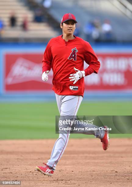 Shohei Ohtani of the Los Angeles Angels runs the bases as he warms up for the spring training game against the Los Angeles Dodgers at Dodger Stadium...