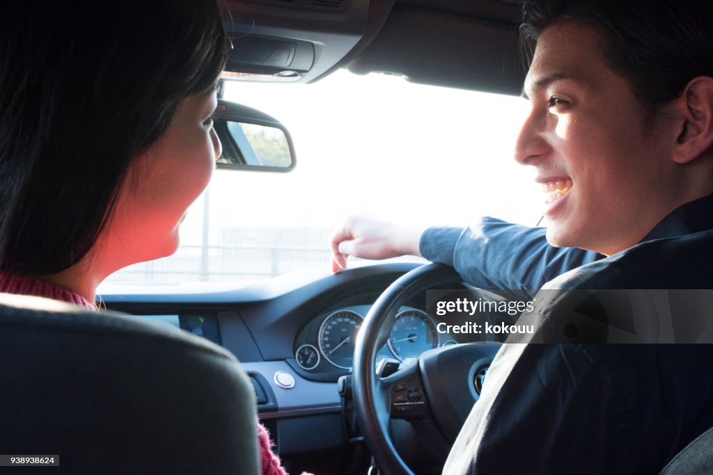 A couple talking while driving.