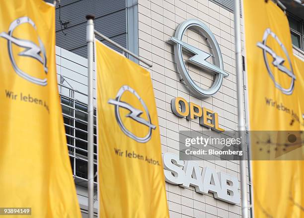 Opel flags fly in front of Opel and Saab signage at the headquarters of Adam Opel GmbH in Ruesselsheim, Germany, on Friday, Dec. 4, 2009. General...