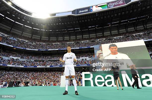 Real Madrid's new player Portuguese Cristiano Ronaldo gives the thumbs up during his official presentation at the Santiago Bernabeu stadium in Madrid...