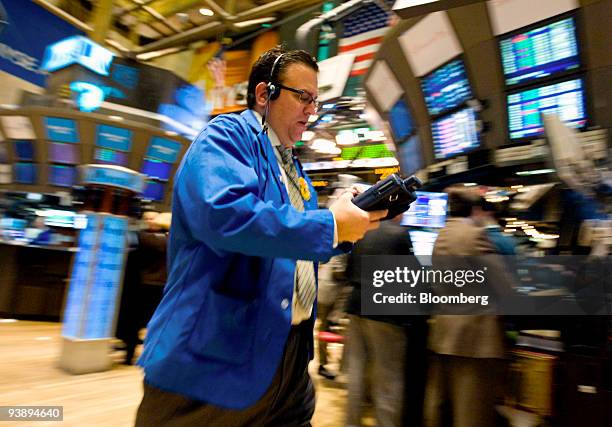 Trader works on the floor of the New York Stock Exchange in New York, U.S., on Friday, Dec. 4, 2009. Stocks rallied, while Treasuries slid and gold...