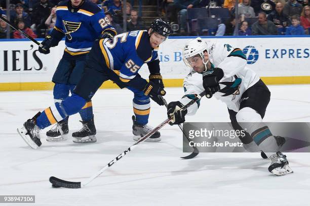 Dylan DeMelo of the San Jose Sharks handles the puck past Colton Parayko of the St. Louis Blues at Scottrade Center on March 27, 2018 in St. Louis,...