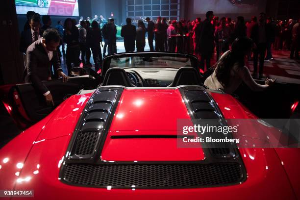 Attendees inspect the Audi AG R8 V10 Plus sport vehicle during an event in New York, U.S., on Tuesday, March 27, 2018. Audi is heavily promoting its...