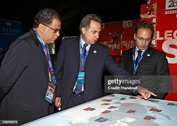 In this handout image provided by the 2010 FIFA World Cup Organising Committee South Africa, Vitaly Mutko shows 2010 FIFA World Cup South OC CEO...