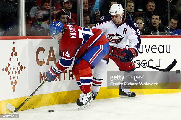 Sergei Kostitsyn of the Montreal Canadiens and Rostislav Klesla of the Columbus Blue Jackets battle for the puck during the NHL game on November 24,...
