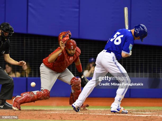 Catcher Francisco Pena of the St. Louis Cardinals prepares to run for the ball near Ryan Borucki of the Toronto Blue Jays during the MLB preseason...