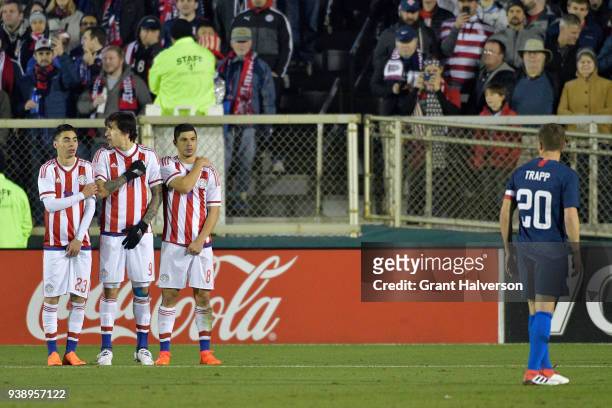 Miguel Almiron, Federico Santander and Rodrigo Rojas of Paraguay defend a direct kick by Wil Trapp of United States during their game at WakeMed...