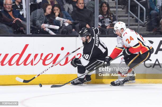Tobias Rieder of the Los Angeles Kings handles the puck against Travis Hamonic of the Calgary Flames at STAPLES Center on March 26, 2018 in Los...