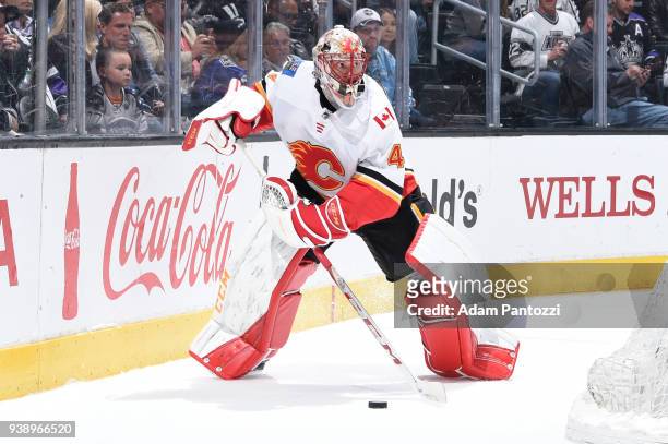 Mike Smith of the Calgary Flames handles the puck during a game against the Los Angeles Kings at STAPLES Center on March 26, 2018 in Los Angeles,...
