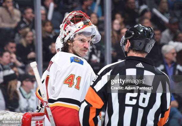 Mike Smith of the Calgary Flames and referee Chris Lee converse during a game against the Los Angeles Kings at STAPLES Center on March 26, 2018 in...