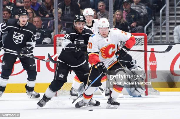 Curtis Lazar of the Calgary Flames handles the puck against Alec Martinez of the Los Angeles Kings at STAPLES Center on March 26, 2018 in Los...