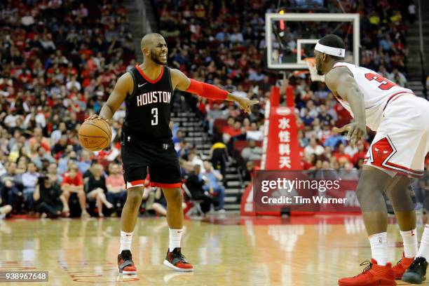 Chris Paul of the Houston Rockets brings the ball down the court defended by Noah Vonleh of the Chicago Bulls in the second half at Toyota Center on...