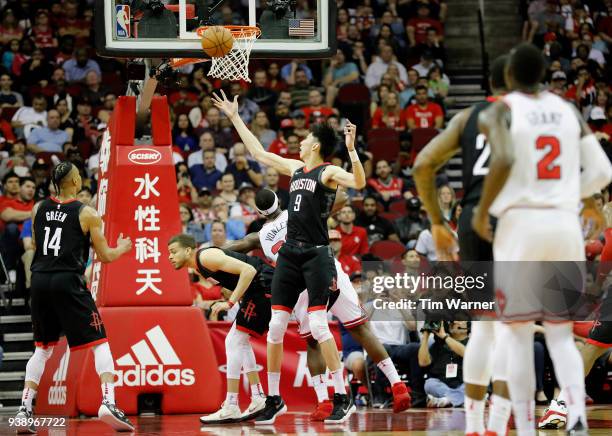 Zhou Qi of the Houston Rockets battles Noah Vonleh of the Chicago Bulls for a rebound in the second half at Toyota Center on March 27, 2018 in...