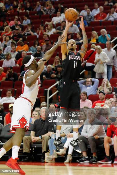 Gerald Green of the Houston Rockets takes a three point shot defended by Noah Vonleh of the Chicago Bulls in the second half at Toyota Center on...