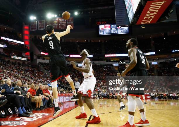 Zhou Qi of the Houston Rockets passes the ball in front of Noah Vonleh of the Chicago Bulls in the second half at Toyota Center on March 27, 2018 in...