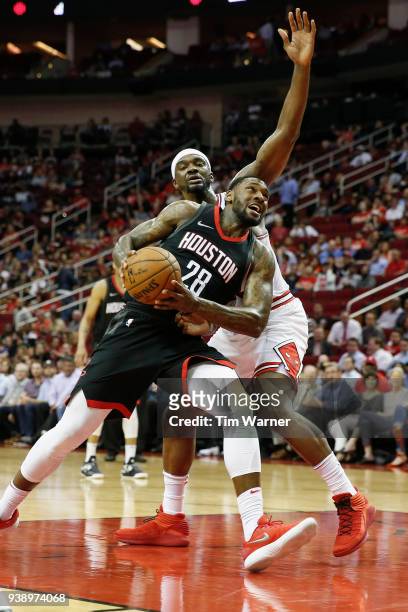Tarik Black of the Houston Rockets drives to the basket defended by Noah Vonleh of the Chicago Bulls in the second half at Toyota Center on March 27,...