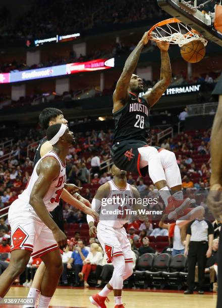 Tarik Black of the Houston Rockets dunks the ball in the second half defended by Noah Vonleh of the Chicago Bulls and David Nwaba at Toyota Center on...