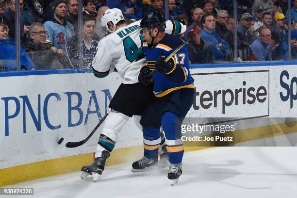 Jaden Schwartz of the St. Louis Blues checks Marc-Edouard Vlasic of the San Jose Sharks off of the puck at Scottrade Center on March 27, 2018 in St....