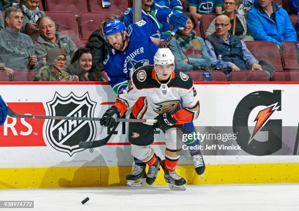 Troy Terry of the Anaheim Ducks checks Sam Gagner of the Vancouver Canucks during their NHL game at Rogers Arena March 27, 2018 in Vancouver, British...