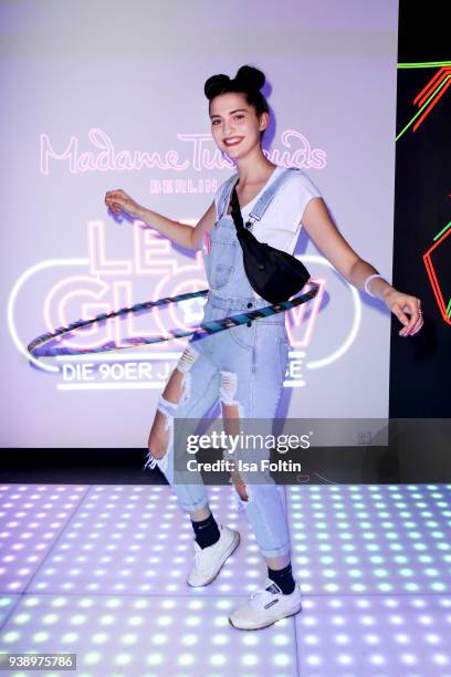 Model Fata Hasanovic is doing Hula Hoop during the 'VIP 90's Let's Glow' Opening Party at Madame Tussauds on March 27, 2018 in Berlin, Germany.