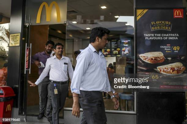 Customers exit a McDonald's Corp. Restaurant, operated by Hardcastle Restaurants Pvt., in Mumbai, India, on Tuesday, March 20, 2018. As the world's...