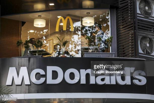Signage for McDonald's Corp. Is displayed outside a restaurant, operated by Hardcastle Restaurants Pvt., in Mumbai, India, on Tuesday, March 20,...