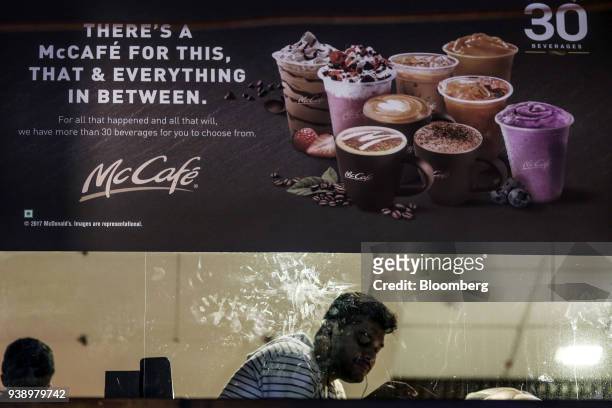 McCafe menu items are advertised in the window of a McDonald's Corp. Restaurant, operated by Hardcastle Restaurants Pvt., in Mumbai, India, on...