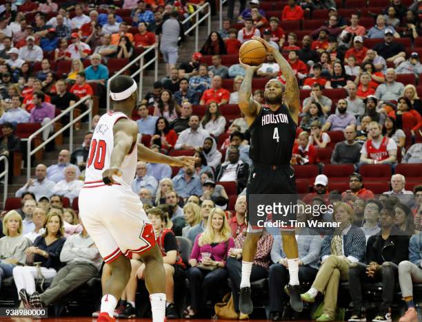 Tucker of the Houston Rockets takes a three point shot defended by Noah Vonleh of the Chicago Bulls in the second half at Toyota Center on March 27,...