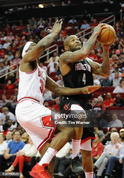 Tucker of the Houston Rockets goes up for a shot defended by Noah Vonleh of the Chicago Bulls in the second half at Toyota Center on March 27, 2018...