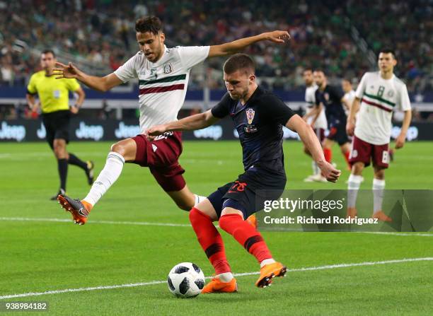 Diego Reyes of Mexico defends as Ante Rebic of Croatia tries to set up a shot in an international friendly soccer match at AT&T Stadium on March 27,...