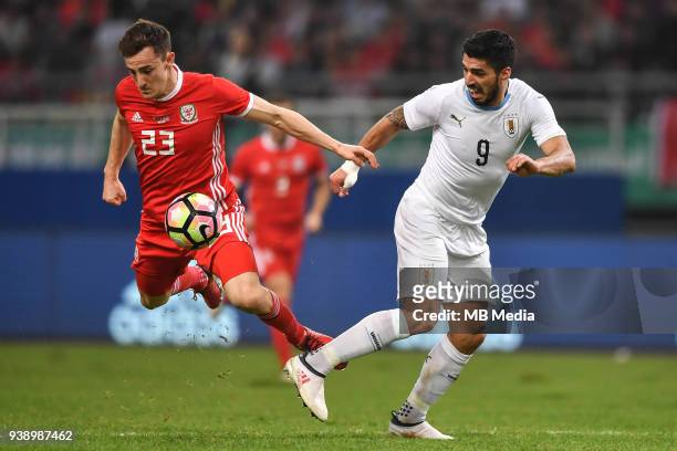 Luis Suarez, right, of Uruguay national football team kicks the ball to make a pass against Tom Lockyer of Wales national football team in their...