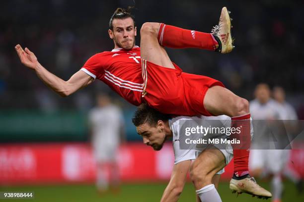 Player of Uruguay national football team challenges Gareth Bale, top, of Wales national football team in their final match during the 2018 Gree China...